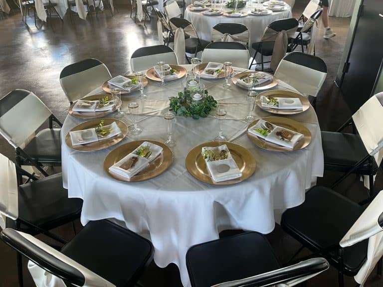 Round dinner table with gold chargers set for Friendsgiving at Connection Room in Cottonwood AZ