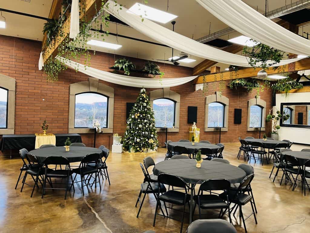 Company holiday party setup with round tables and Christmas tree at Connection Room in Cottonwood AZ